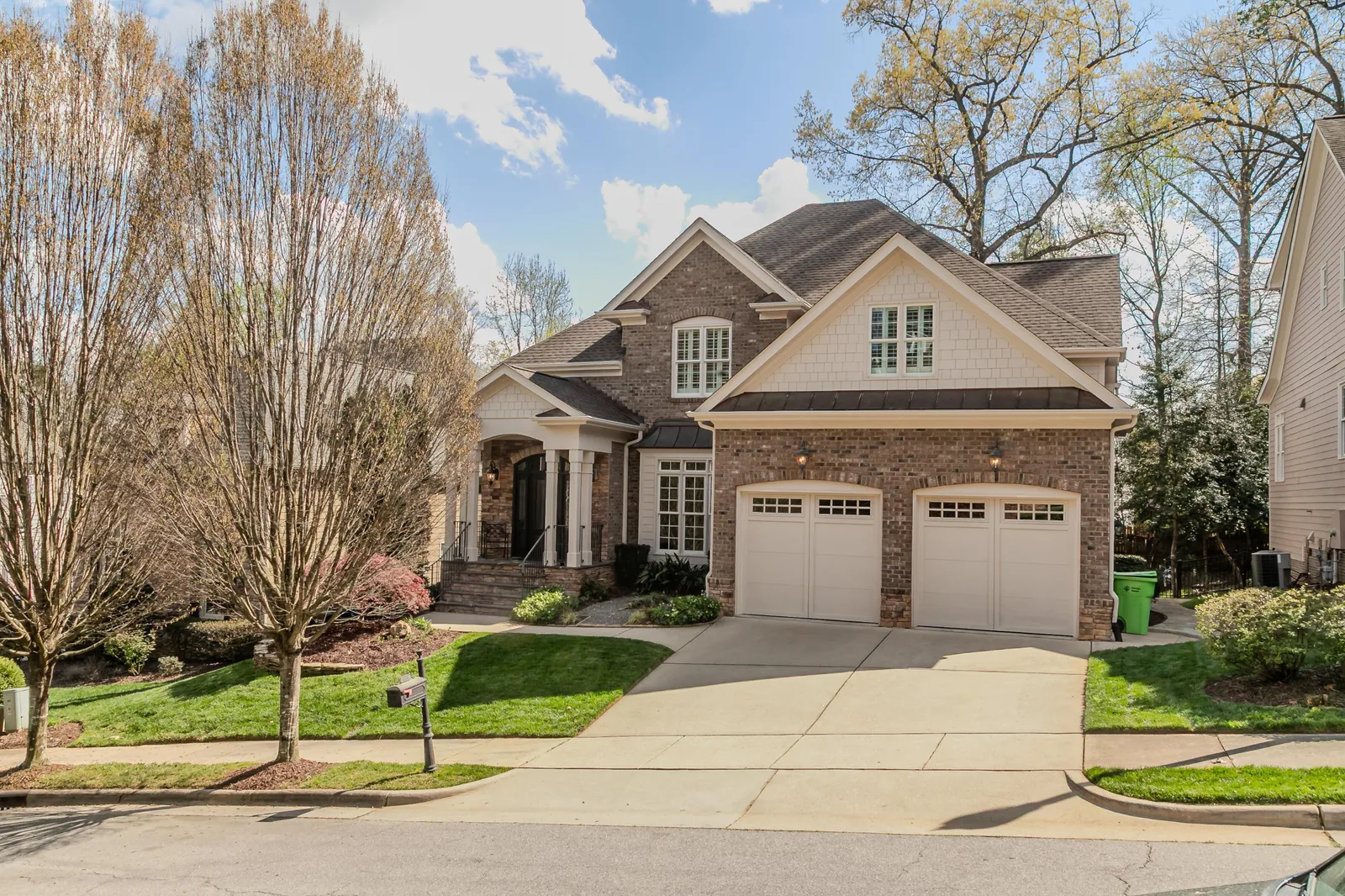 Two-story brick home with a two-car garage and a landscaped front yard